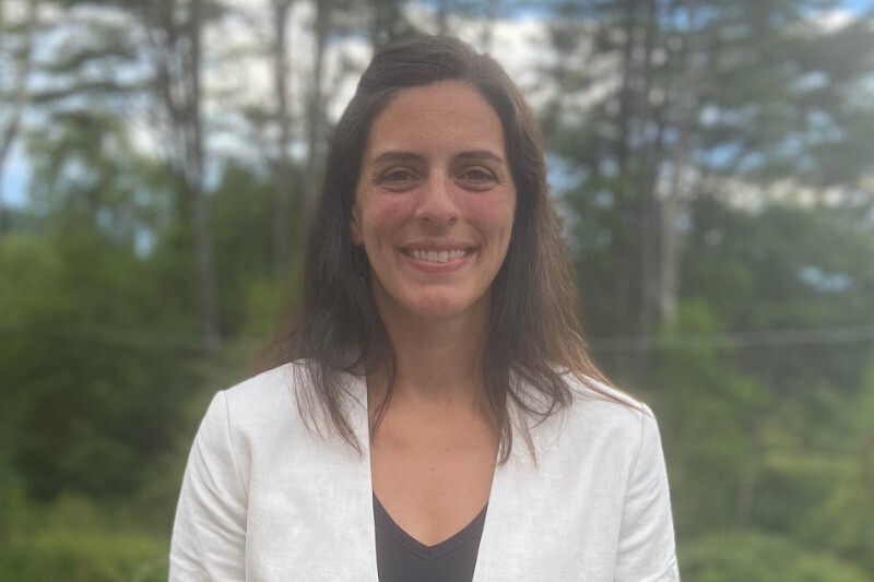 Photo of Alison Lamagna with woods in the background.