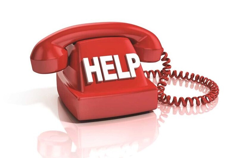 Old red telephone with HELP on the front.