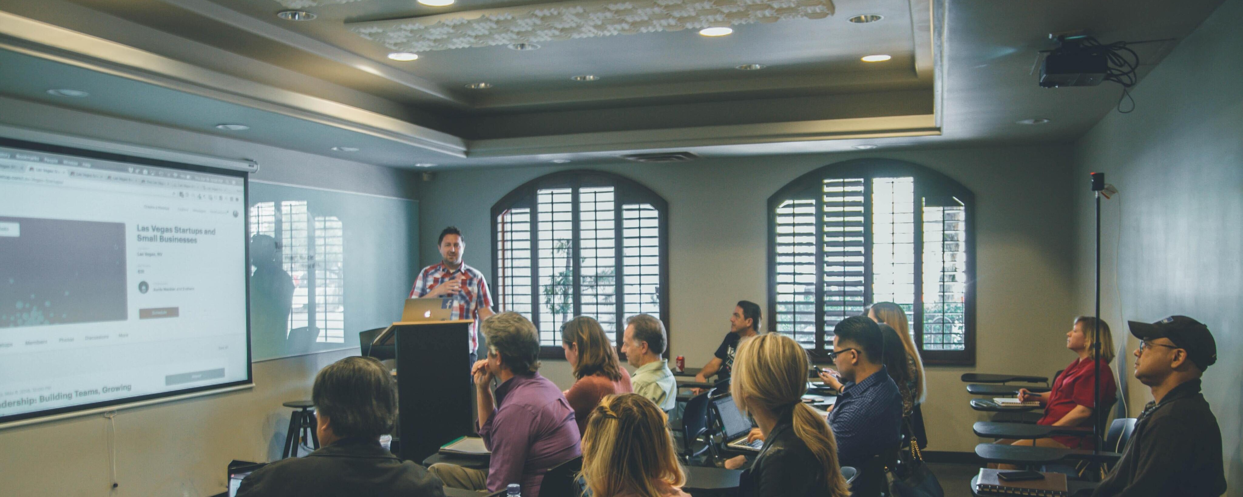 stock image of a teacher with a class audience